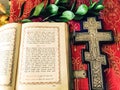 Ancient Holy Bible on Old Russian language and a silver Orthodox crucifix Royalty Free Stock Photo