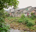 Ancient houses along brook after summer rain