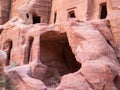 Ancient housing carved in red sand rock in the city of Petra, Jordan. Detail with Tomb of `Unayshu