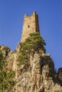 An ancient impregnable stone castle built on the pinnacles of steep rocky cliffs.