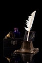 Ancient Inkwell, feather pen, old paper and a vintage bell Royalty Free Stock Photo