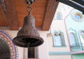 Ancient iron bell on the background of a wooden structure