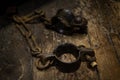 Ancient iron handcuffs on wooden floor from medieval times in England, prisoner wrist restraints. Royalty Free Stock Photo