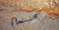 Ancient iron key, the sea washed up on the sand Royalty Free Stock Photo