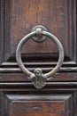 Ancient italian door knocker on wooden brown door Royalty Free Stock Photo