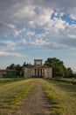 Ancient Italian Neoclassical House inside Park and Blue Sky with Clouds