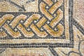 Ancient Italian Roman mosaic floor with circular shapes composed of small colored stone tiles - corner concept Royalty Free Stock Photo