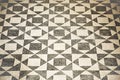 Ancient Italian Roman mosaic floor with triangular shapes composed of small white and black stone pebbles Royalty Free Stock Photo