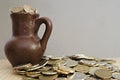 Ancient jug with coins. Old coins in a pot.