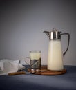 Ancient jug with milk and a glass on wooden table. space for text Royalty Free Stock Photo