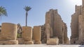 The ancient Karnak Temple in Luxor. Stone walls and the passage between the colonnades against the blue sky. Royalty Free Stock Photo