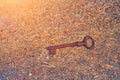 An ancient key lies in the water on the yellow sand of the beach