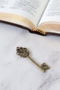 Ancient key with open holy bible book Royalty Free Stock Photo