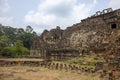 Ancient khmer temple view in Angkor Wat complex, Cambodia. Buddha face on Phnom Bakheng temple wall.