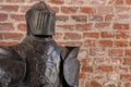 Knight armour against brick wall background Royalty Free Stock Photo