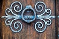 Ancient knocker on old wood door