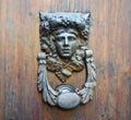 Ancient knocker on an old wooden door Royalty Free Stock Photo