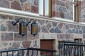 Ancient lanterns on the wall of a stone house. Wrought iron lamp