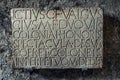 Ancient latin script carved into marble at Pompeii, Italy