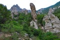 Ancient limestone high mountains of rounded forms in air haze. Valley of Ghosts. DemerdzhiDemerji. Green trees and bushes