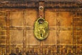 Ancient locked rusted treasure chest with large brass lock