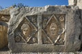 Ancient Lycian stone slab with portraits of people carved in stone in geometric form with floral decoration