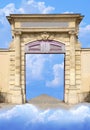 Ancient magical mystical medieval wall gateway to path leading out to heaven in the sky with clouds Royalty Free Stock Photo