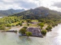 Ancient Marae Taputapuatea temple complex, lagoon shore with mountains background. Raiatea island. French Polynesia, Oceania. Royalty Free Stock Photo