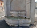 ancient marble fountain with flowing water in Botticino, Brescia, Italy Royalty Free Stock Photo