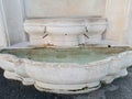 ancient marble fountain with flowing water in Botticino, Brescia, Italy Royalty Free Stock Photo