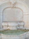 ancient marble fountain with flowing water in Botticino, Brescia, Italy Royalty Free Stock Photo