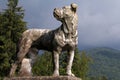 Ancient marble statue of a hunting dog on a background of Carpathian mountains, Peles Castle, Sinaia, Romania Royalty Free Stock Photo