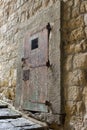 Ancient massive wooden door in medieval fortress. Old entrance in european castle in Italy.