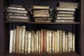 Ancient medieval books on the shelf in the bookcase