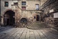 Ancient medieval house. In brick and stone, exterior part with entrance and stairs. Royalty Free Stock Photo