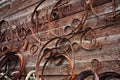 Ancient medieval rusty metal hardware and forged rim on a wooden wall Royalty Free Stock Photo