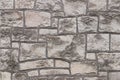 Ancient medieval stone masonry. Texture of a fragment of a wall of an old structure. A background for design and creative work. De Royalty Free Stock Photo