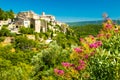 Ancient medieval village with flowers of Gordes, Provence, France Royalty Free Stock Photo