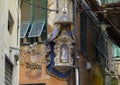 Ancient memorial kiosk with statue Madonna on a wall in Genoa, northern Italy