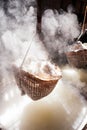 Ancient method of boiling brine into pure salt in Bo Kluea, Nan, Thailand. Beautiful smoke, sunlight shines down around ancient Royalty Free Stock Photo