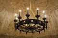 An ancient Middle Ages chandelier on a brick castle ceiling