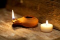 Ancient Middle Eastern oil lamp made in clay on wood table Royalty Free Stock Photo