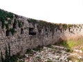 Ancient stone fortress wall with iron cannons and vine plant Royalty Free Stock Photo