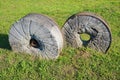 Ancient millstone on the grass, natural background Royalty Free Stock Photo