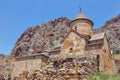 Ancient Monastery Noravank built of natural stone tuff. Landscaped view of the stone mountains.