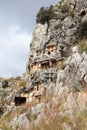 Ancient monumental lycian rock-cut tombs in archaeological site Myra near Demre, Turkey with goats grazing among them Royalty Free Stock Photo