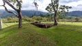 An ancient mound dolmen. Monolithic tomb formed with volcanic rocks into grass at Colombian San Agustin archaeological park