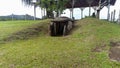 An ancient mound dolmen. Monolithic tomb formed with volcanic rocks into grass at Colombian San Agustin archaeological park.