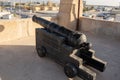 Ancient Museum canon on top of a look out at a middle eastern fort at the Ras al Khaimah Museum in the United Arab Emirates Royalty Free Stock Photo