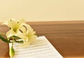 Ancient Musical Manuscript, Abstract Music Sheet and flowers on wooden table Royalty Free Stock Photo